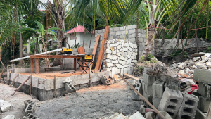 An outdoor kitchen shower room, and septic tank is being built in Raket.