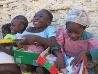 Beaming happy children with their gifts