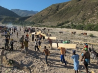 Children from the mountains carrying benchparts up the mountain