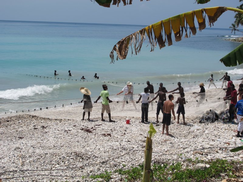 Bill helping pull in a fishing net on the south coast of Haiti
