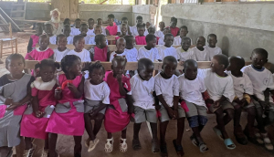 Bill with the children in their uniforms