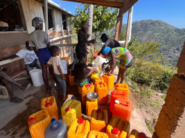 Villagers filling their water jugs at the cistern instead of having to walk 3 miles to get it!!