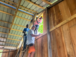 B.J. helping put up boards on church/school in Janou