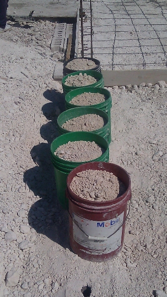 We began to improve our system. We put gravel into buckets while the last batch was mixing. Then poured the buckets into the cement mixer.