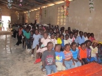 Children waiting for their dinner to be served before watching the Jesus Film.