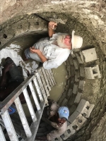 Bill helping to line the well with concrete blocks.