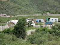 Yvrose's place with three buildings and the school tents.