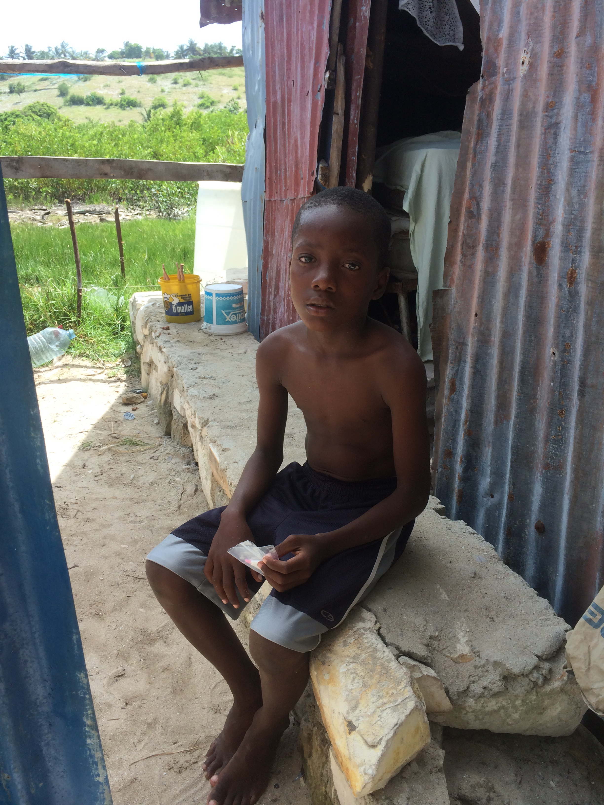 A little boy with his medicine for Chikungunya.