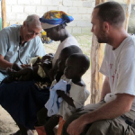 Dr. Alfredo examining patients at the mountain clinic with Cristin looking on