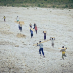 Children carrying bench parts up the mountain