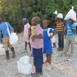 Children preparing to take food for the school lunch program up the mountain.