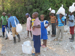 Children preparing to take food for the school lunch program up the mountain.