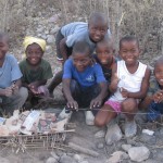 Yvrose’s children with play village they built, complete with “electric” lines