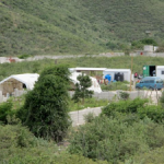 Overlooking Yvrose’ home with the school tents, the three metal buildings the family lives in