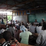 Meeting at the school to tell the people about Hurricane Tomas and the cholera outbreak