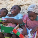 Happy little girls opening their gifts