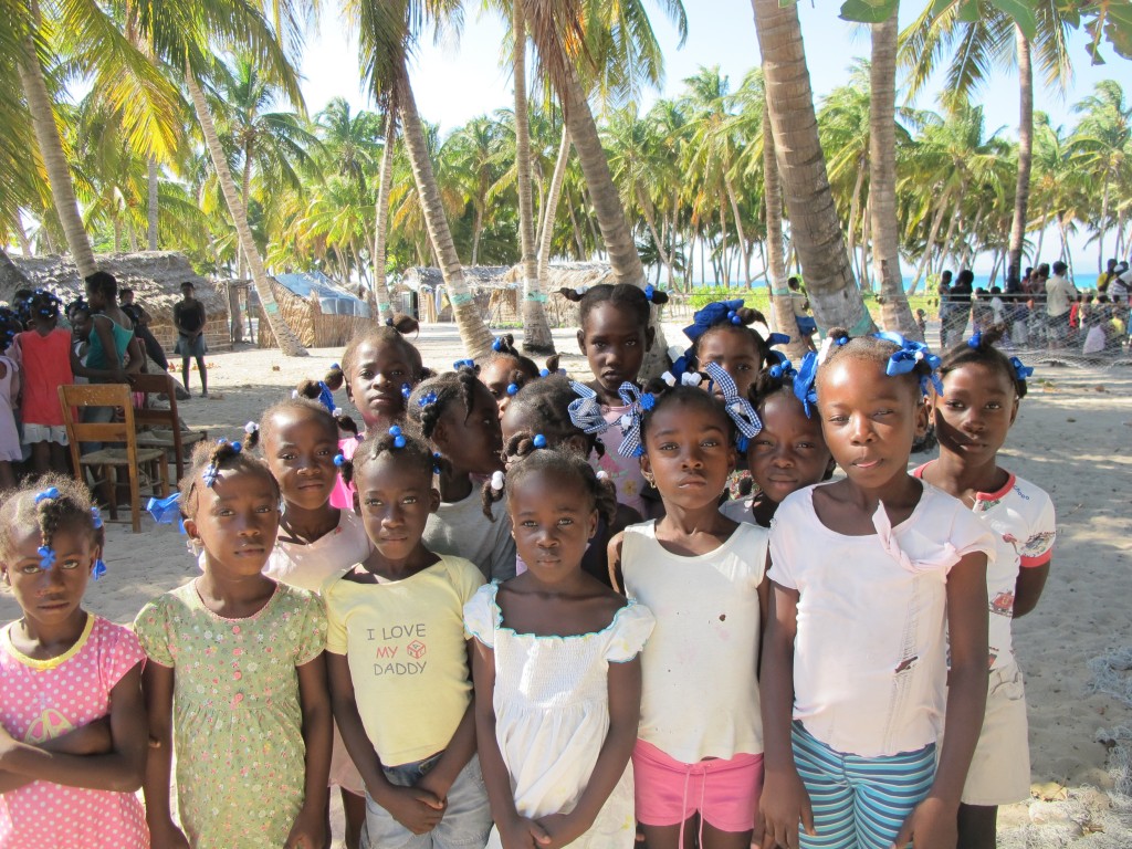 Children of the island with their homes behind them