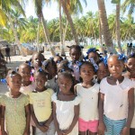 Children of the island with their homes behind them