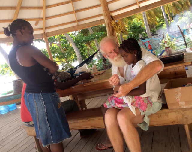 Bill giving a girl medicine for Chikungunya