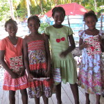 Four neighborhood girls with their new clothes  (Cynthia is in the green dress)