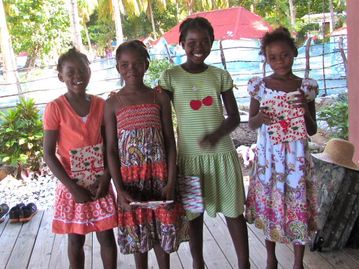 Four neighborhood girls with their new clothes (Cynthia is in the green dress)