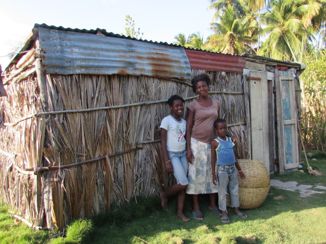 Paulette with two of her children in front of her home. Mackenzie & Mason helped her with a small "loan" to start a little business.  We are praying it will be a success to help her feed her family.