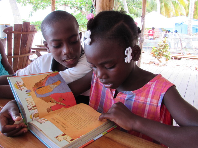 Ashley reading the Jesus Storybook Bible in Creole