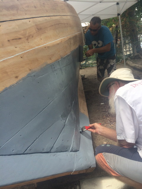 Painting the undercoat of paint on the boat