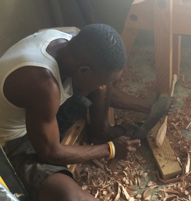 Soner shaping the spoon with a machete