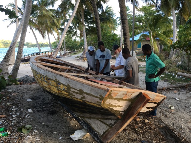 Bill helping repair a local fisherman's boat
