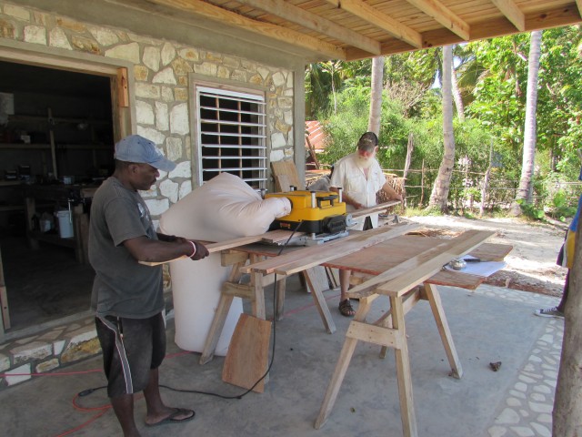 Bill and Christophe planing down some board on the porch of the shop