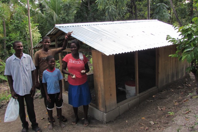 Mssr. Yvon's family with eggs from the chickens in the chicken house JUST MERCY built