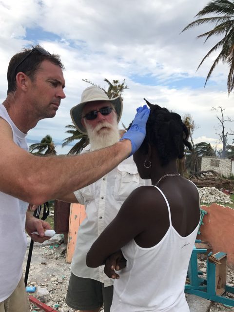 Eric treating a woman, one of many who needed medical help.